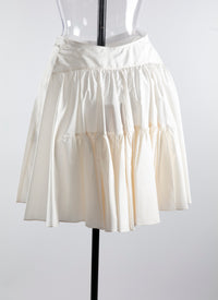 Short flared skirt with silk buttons - White